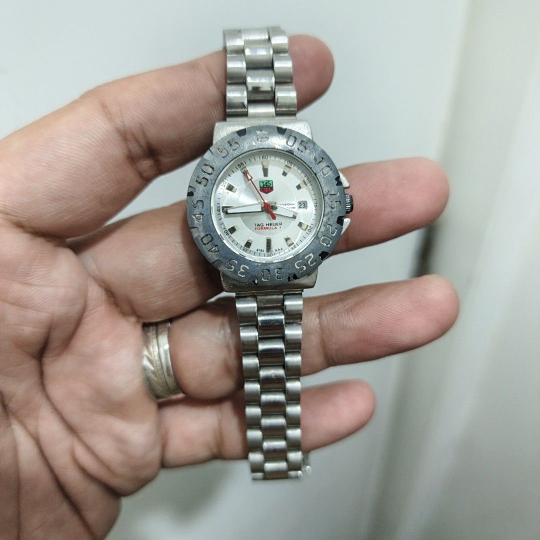 TAG Heuer Formula 1 Quartz Watch (Category: Luxury Watches) located in Manila. Submitted by narju1234 (Listing ID 1467370050, Image 2). Description: - Brand/Model: TAG Heuer Formula 1 - Movement: Battery-powered quartz (keeps time well) - Dial: Silver with striking red second hand and date window at 3 o'clock - Bezel: Grey rotating bezel with numeric markers - Bracelet: Stainless steel link bracelet - Condition: Shows normal signs of wear on the 