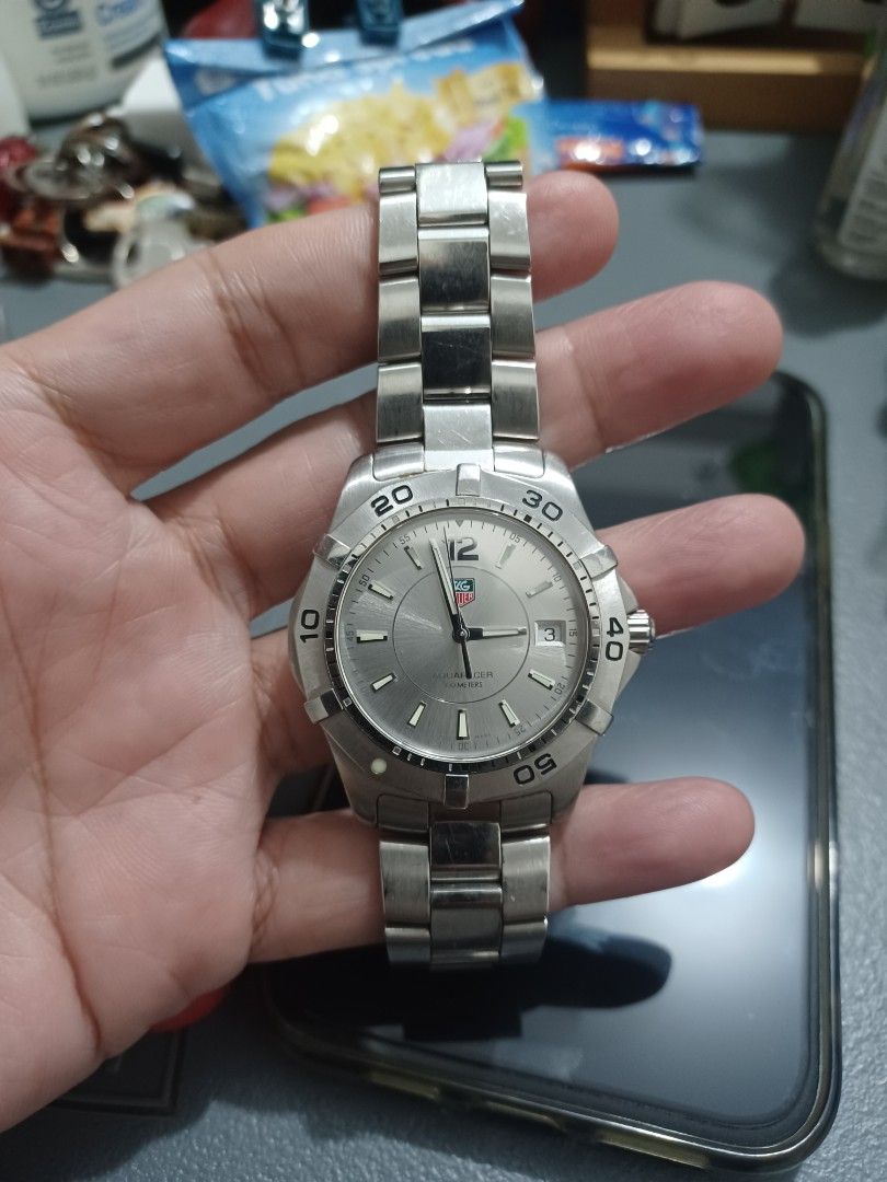 TAG Heuer Silver Dial Steel Watch (Category: Luxury Watches) located in Mandaluyong City. Submitted by usamenfashionhaul (Listing ID 1467575684, Image 2). Description: - Authentic TAG Heuer wrist watch - Clean silver dial with a classic sporty design - Rotating bezel with numeric markings up to 50 - Date window conveniently located near the 3 o'clock mark - Durable stainless steel bracelet (metal band shows normal signs of wear) - Perfect everyda