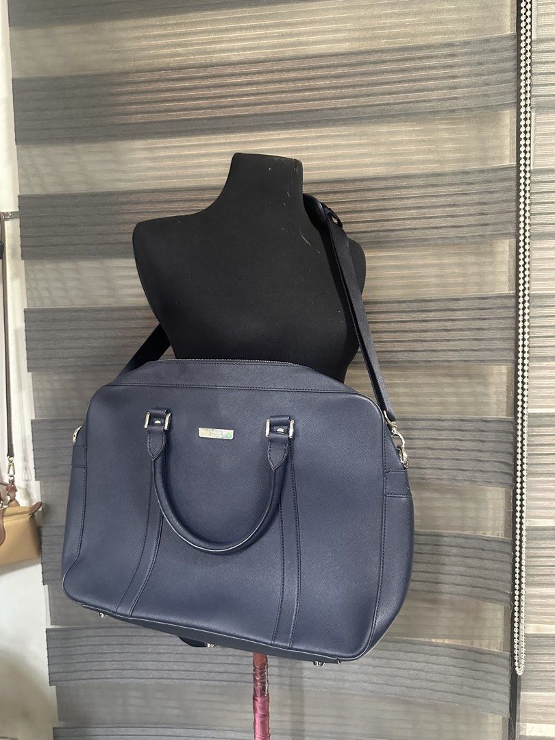 Takeo kikuchi Briefcase Work Bag with Shoulder Strap (Category: Briefcases) located in Quezon City. Submitted by prelovedbagsbygiv (Listing ID 1467474099, Image 1). Description: - Color: Dark blue - Material: Saffiano leather texture - Hardware: Silver-toned with front metal logo plaque - Straps: Twin carry handles and long adjustable shoulder strap - Closure: Double zip top closure - Capacity: Spacious interior, fits a laptop and daily office es