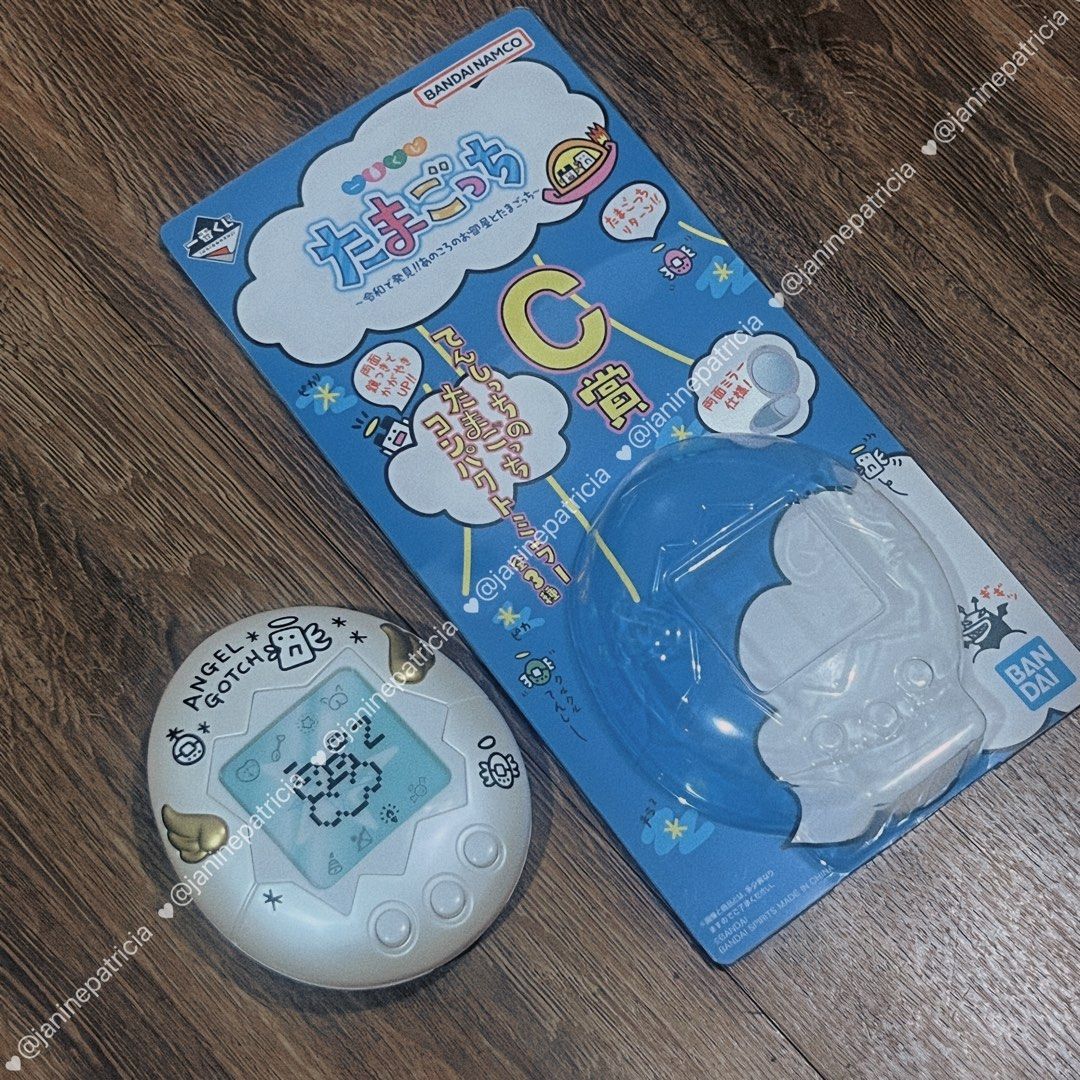 Tamagotchi Angel Gotchi Compact Mirror (Limited Edition) (Category: Character Goods) located in Pasay City. Submitted by janinepatricia (Listing ID 1467406151, Image 2). Description: - Authentic Limited Edition Bandai Namco Ichiban Kuji Tamagotchi item (C Prize - Angel Gotchi compact mirror) - Design: White round case featuring iconic Angel Gotchi graphics and golden wings on the front - Interior: Opens up to dual mirrors - Condition: Brand new-l