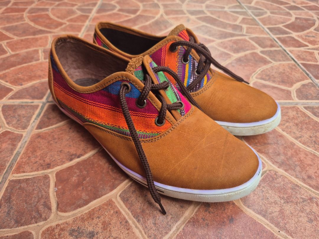 Tan and multi-colored woven pattern casual lace-up shoes (Category: Sneakers) located in Caloocan City. Submitted by munchie787906 (Listing ID 1467517769, Image 2). Description: - Style: Casual lace-up sneakers with vibrant woven side and tongue patterns - Color: Tan with multi-colored stripes and brown accents - Size: EU 38 - Details: Brown laces, brown leather-look collar trim, and white outer soles - Condition: Light dirt on soles from brief w