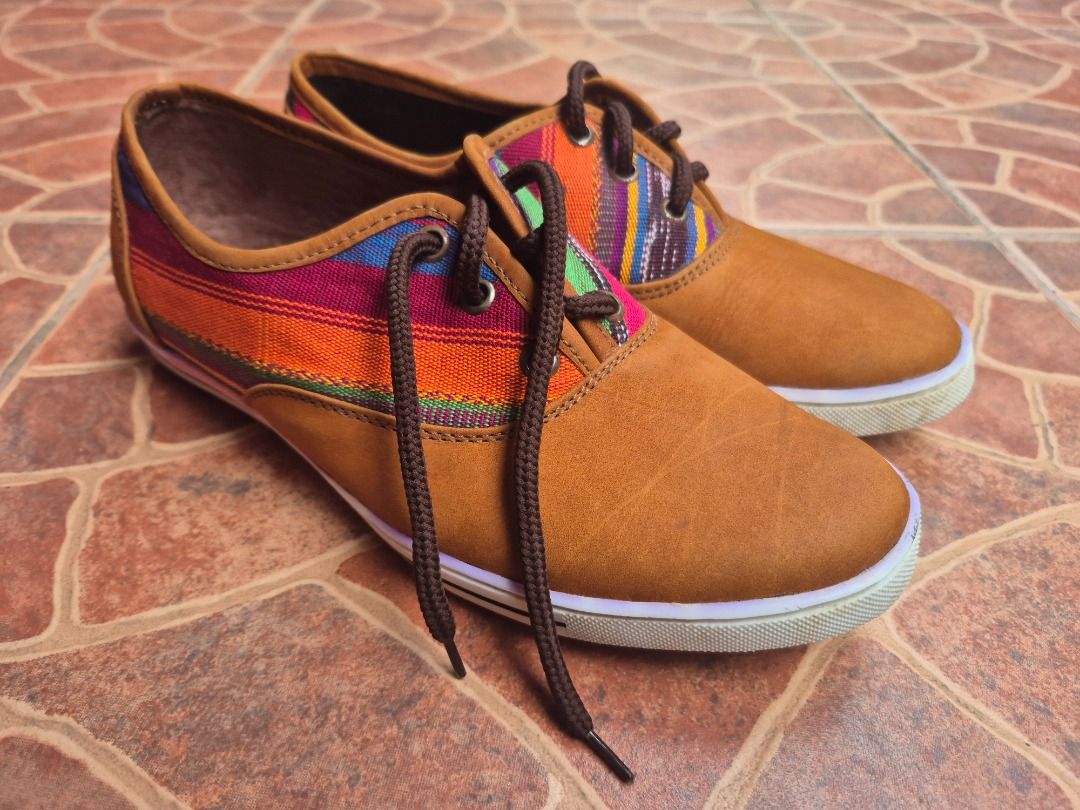 Tan and multi-colored woven pattern casual lace-up shoes (Category: Sneakers) located in Caloocan City. Submitted by munchie787906 (Listing ID 1467517769, Image 3). Description: - Style: Casual lace-up sneakers with vibrant woven side and tongue patterns - Color: Tan with multi-colored stripes and brown accents - Size: EU 38 - Details: Brown laces, brown leather-look collar trim, and white outer soles - Condition: Light dirt on soles from brief w