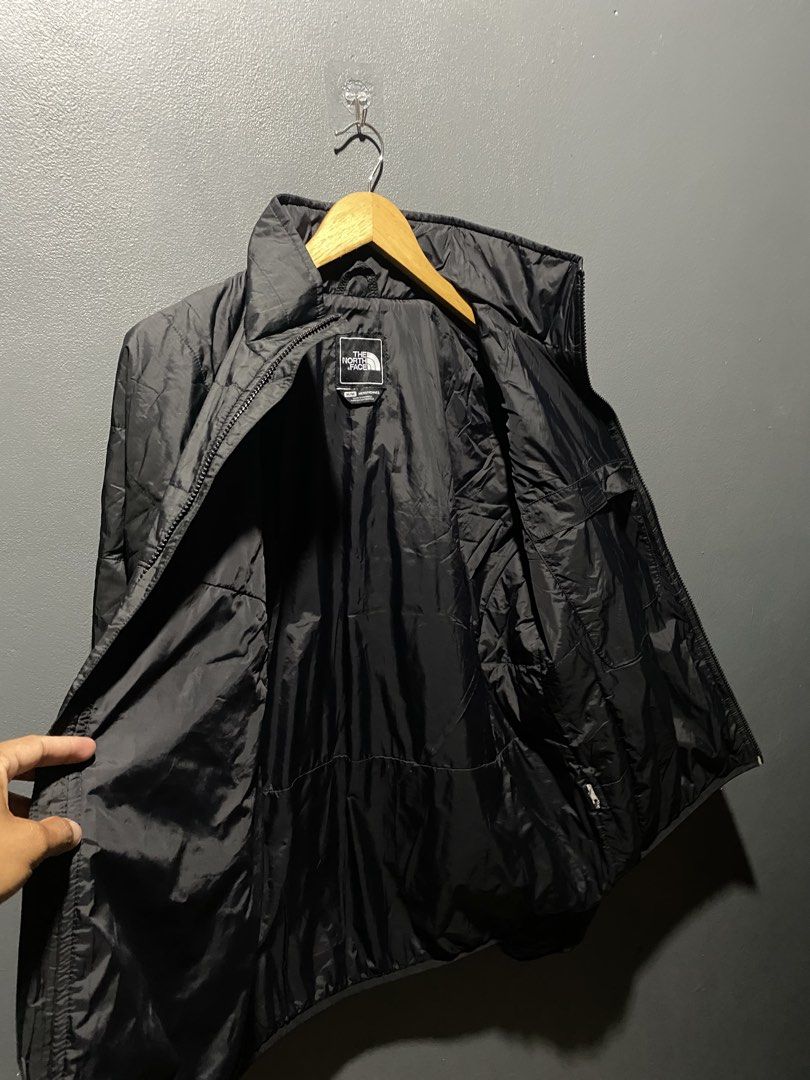 The North Face Black Puffer Jacket Size M (Category: Coats, Jackets and Outerwear) located in Lucena. Submitted by handpickthrift (Listing ID 1467499639, Image 3). Description: - Brand: The North Face - Style: Quilted zip-up jacket with high mock neck - Size: Men's Medium - Color: Black with white embroidered chest logo - Material: Grid-pattern ripstop outer shell with clean inner lining and good loft - Hardware: YKK Vislon front zipper - Conditi