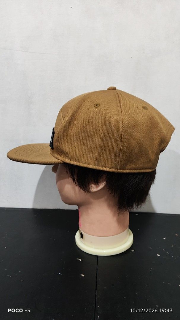 The North Face Brown Snapback Cap (Category: Caps & Hats) located in Quezon City. Submitted by ralphralph (Listing ID 1467498995, Image 3). Description: - Brand: The North Face - Style: Classic 5-panel snapback cap with a flat brim - Color: Brown - Details: Woven TNF logo patch on the front right - Fit: Adjustable plastic snap closure in the back - Condition: Clean fabric, sturdy construction, ready to wear.