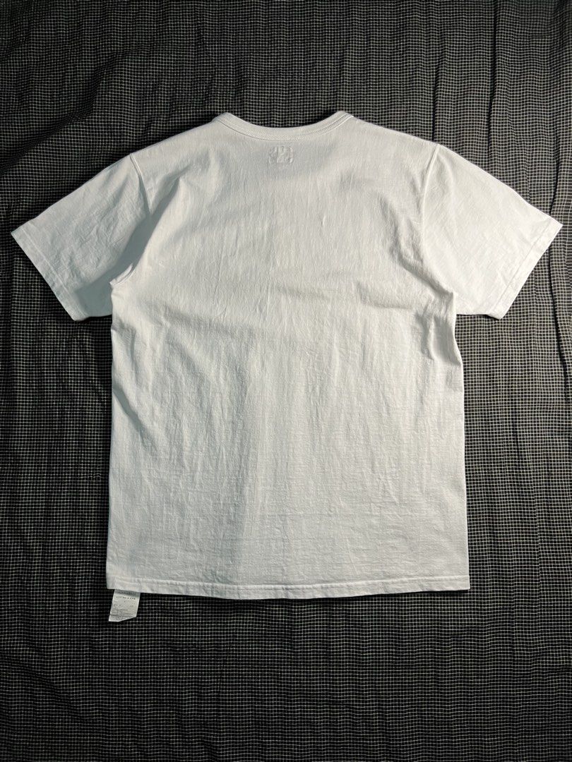 The Real McCoy's Logo Tee (Category: Activewear) located in Zamboanga. Submitted by abubazir7 (Listing ID 1467506835, Image 2). Description: The Real McCoy’s Logo Tee S/S Size Medium Actual dimensions Length 26.5 Width 20 Shoulder 17 This classic white tee is made in Japan from premium mid-weight 8oz heavy cotton jersey, featuring a boxy fit and the brand’s signature winged yellow and pink logo printed on the left chest..