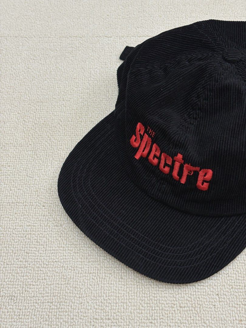 The Spectre Black Corduroy Baseball Cap (Category: Caps & Hats) located in Manila. Submitted by porma.market (Listing ID 1467403749, Image 1). Description: - Color & Material: Premium black corduroy with a clean structure - Design: Bold red 'THE Spectre' embroidery with a unique gun graphic inside the letter 'r' - Fit: Comfortable fit with an adjustable metal strapback closure - Details: Includes inner lining and authentic branded tags - Conditio