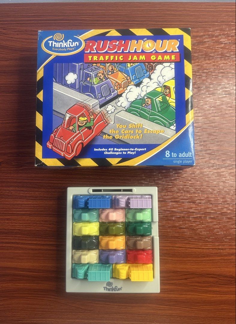 ThinkFun Rush Hour Traffic Jam Game (Category: Board Games & Puzzles) located in Makati City. Submitted by cecille1998 (Listing ID 1467399872, Image 1). Description: - Game: Original ThinkFun Rush Hour Traffic Jam Puzzle - Age Range: 8 years to adult (Single player) - Inclusion: Complete set with grid board, all colorful vehicles, 40 challenge cards (beginner to expert), color code card, and yellow storage bag - Packaging: Comes with original box