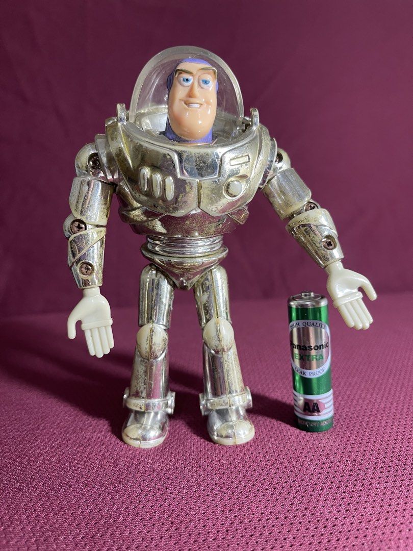 Thinkway Toys Disney Pixar Buzz Lightyear Silver Figure (Category: Figurines & Statues) located in Manila. Submitted by dstrangerthings (Listing ID 1467565515, Image 3). Description: - Authentic Disney Pixar Thinkway Toys Buzz Lightyear action figure - Distinct metallic silver finish with visible wear, scuffs, and discoloration on armor and limbs - Joints and plastic parts show expected signs of age and use - Features official Disney Pixar Thinkw