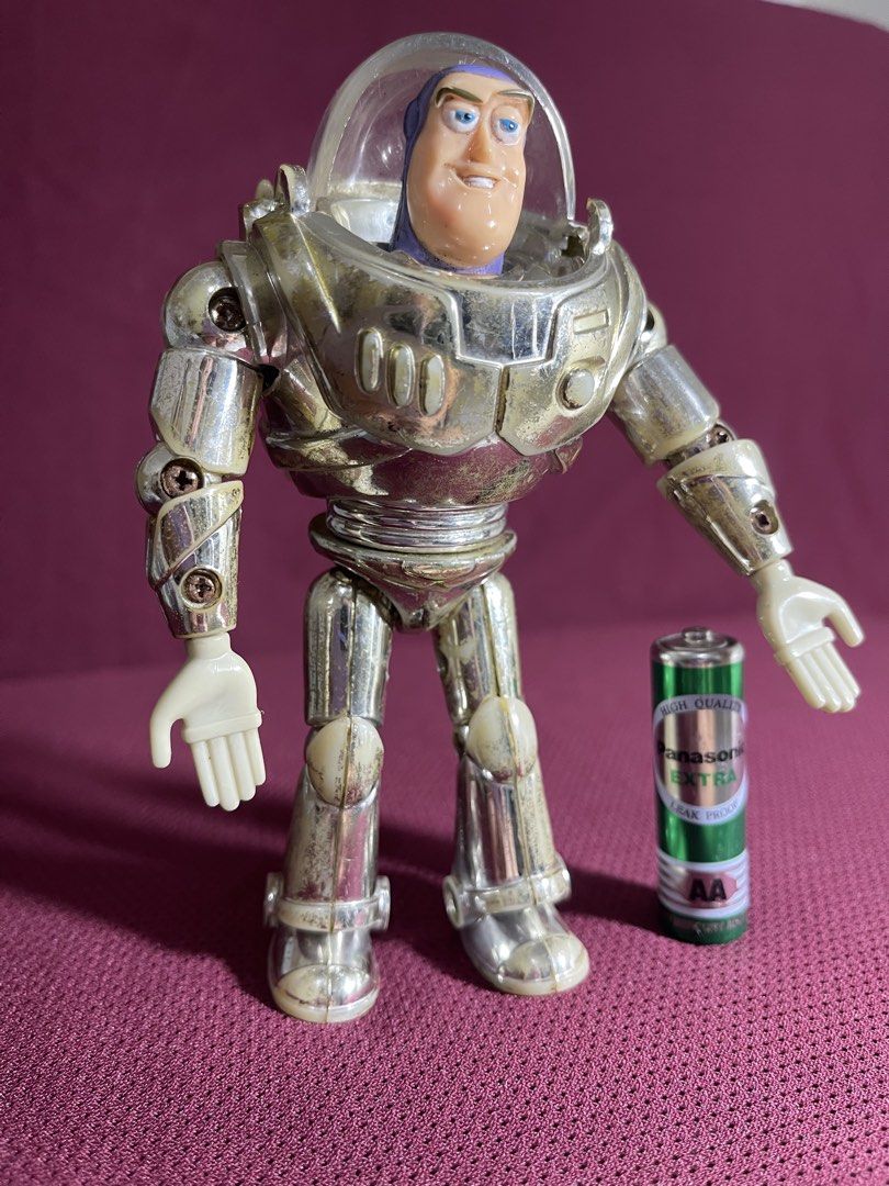 Thinkway Toys Disney Pixar Buzz Lightyear Silver Figure (Category: Figurines & Statues) located in Manila. Submitted by dstrangerthings (Listing ID 1467565515, Image 2). Description: - Authentic Disney Pixar Thinkway Toys Buzz Lightyear action figure - Distinct metallic silver finish with visible wear, scuffs, and discoloration on armor and limbs - Joints and plastic parts show expected signs of age and use - Features official Disney Pixar Thinkw