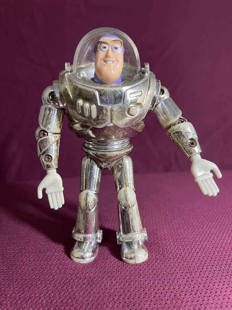 Thinkway Toys Disney Pixar Buzz Lightyear Silver Figure (Category: Figurines & Statues) located in Manila. Submitted by dstrangerthings (Listing ID 1467565515, Image 1). Description: - Authentic Disney Pixar Thinkway Toys Buzz Lightyear action figure - Distinct metallic silver finish with visible wear, scuffs, and discoloration on armor and limbs - Joints and plastic parts show expected signs of age and use - Features official Disney Pixar Thinkw