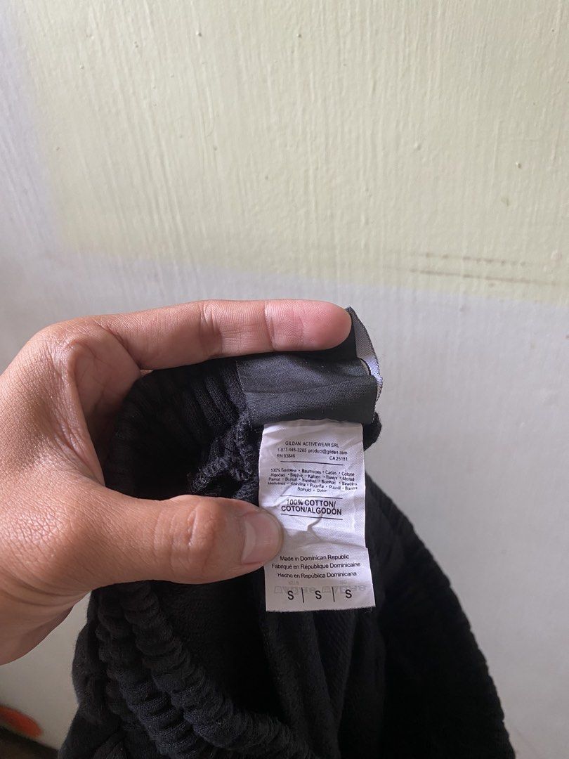Thrasher Black Track Sweatpants Size S (Category: Joggers) located in Pandi. Submitted by nasya_thrift_collection2023 (Listing ID 1467416427, Image 3). Description: - Brand: Thrasher (Manufactured by Gildan Activewear) - Size: Men's Small (Regular Fit) - Color: Black with white logo tape down the leg - Material: 100% Cotton for maximum comfort - Features: Elastic waistband with adjustable drawstring and ribbed ankle cuffs - Condition: Excellent /