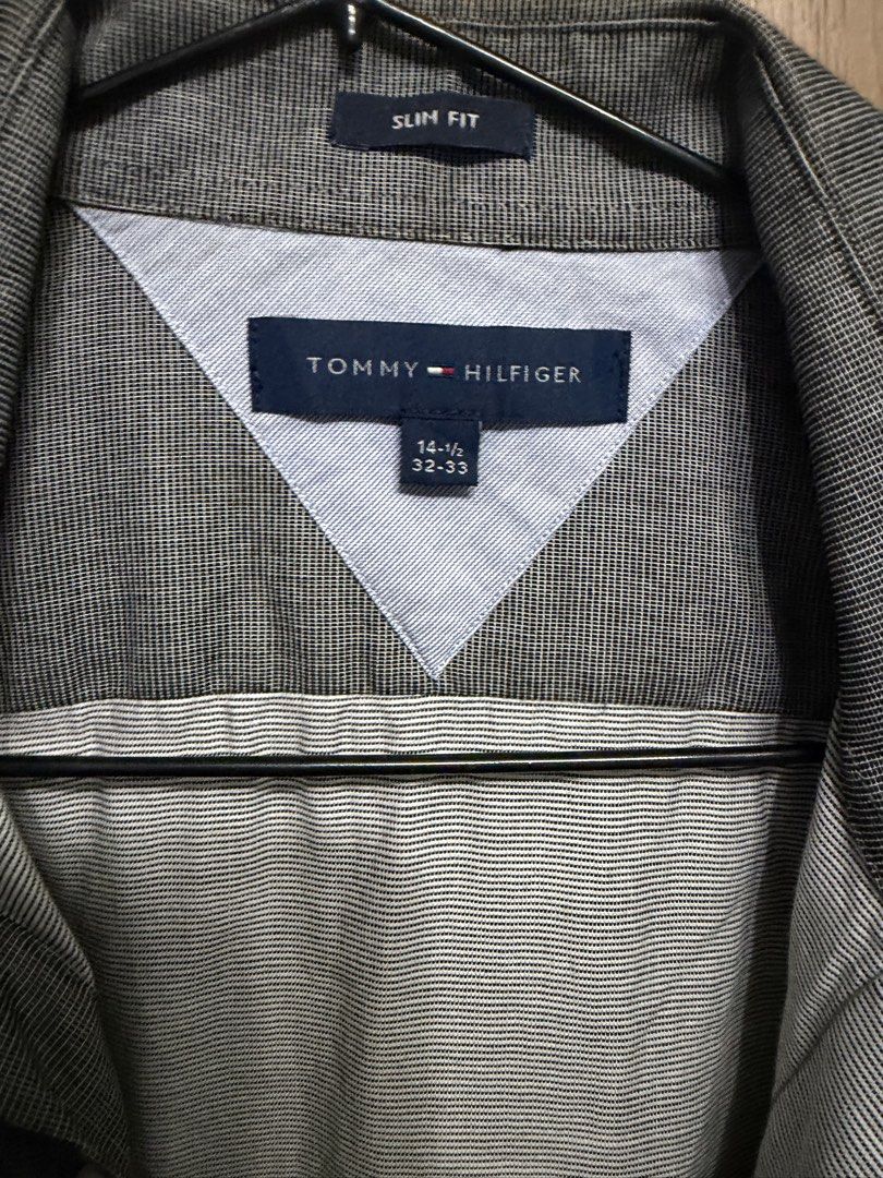 Tommy Hilfiger Slim Fit Grey Button Down Shirt (Category: Formal Shirts) located in Manila. Submitted by marclouiea70819 (Listing ID 1467560435, Image 2). Description: - Brand: Tommy Hilfiger - Color: Grey with micro texture pattern - Fit: Slim fit - Size: 14.5 (Sleeve length: 32-33) - Details: Classic collar, left chest pocket, button-down closure - Material: Lightweight, perfect for office or smart casual wear - Condition: Clean and well-mainta