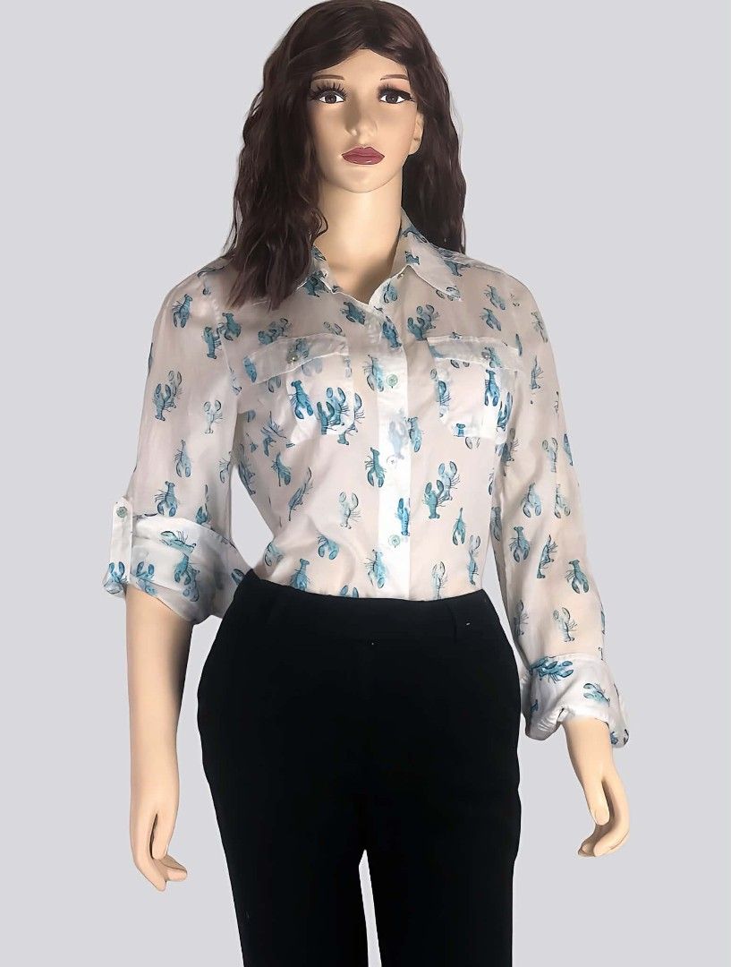 Tory Burch Blue Lobster Print Button-Down Blouse Size 6 (Category: Blouses) located in Pasig City. Submitted by dertah (Listing ID 1467510622, Image 1). Description: - Brand: Tory Burch - Style: Long-sleeve button-down shirt with playful blue lobster print - Size: 6 (Orange brand neck label) - Features: Classic collar neckline, two buttoned chest pockets, roll-tab sleeves secured with green buttons - Material: Lightweight, breathable cotton - Con