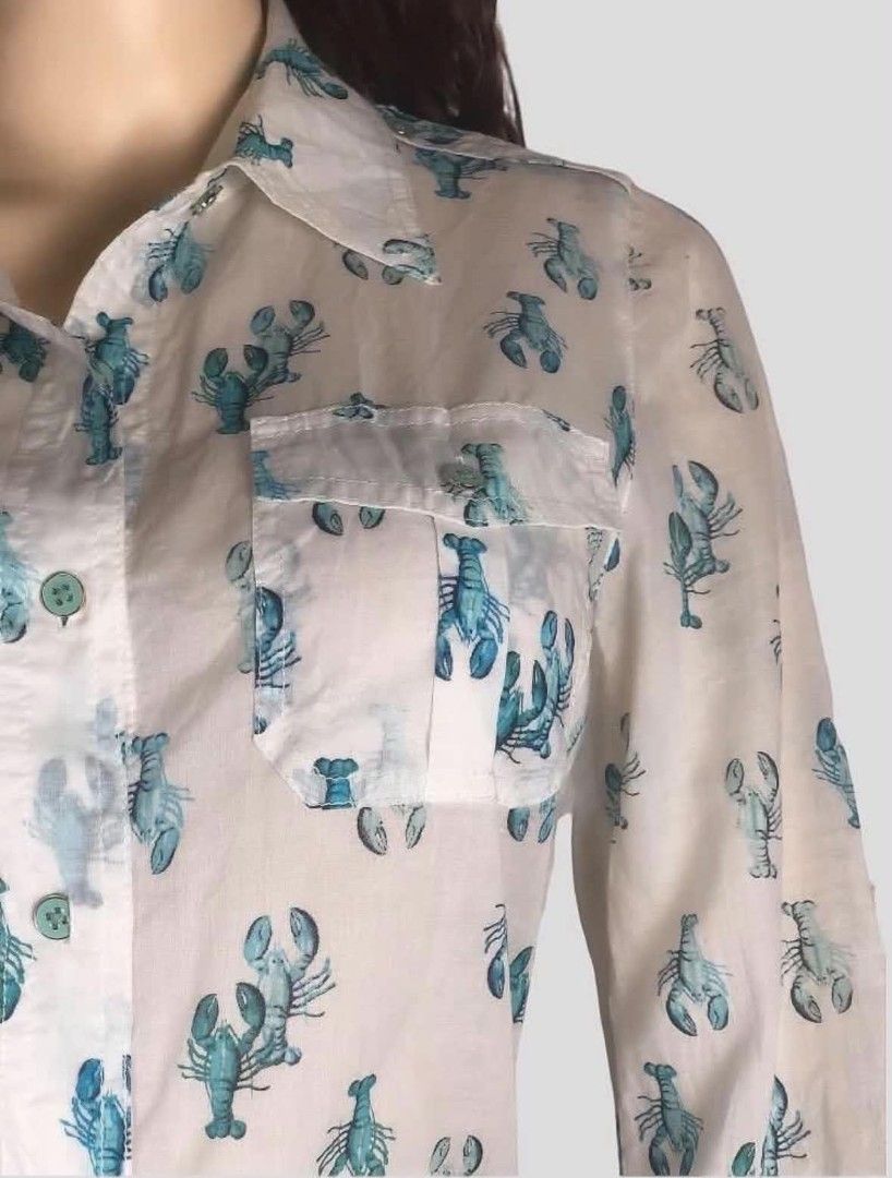 Tory Burch Blue Lobster Print Button-Down Blouse Size 6 (Category: Blouses) located in Pasig City. Submitted by dertah (Listing ID 1467510622, Image 3). Description: - Brand: Tory Burch - Style: Long-sleeve button-down shirt with playful blue lobster print - Size: 6 (Orange brand neck label) - Features: Classic collar neckline, two buttoned chest pockets, roll-tab sleeves secured with green buttons - Material: Lightweight, breathable cotton - Con