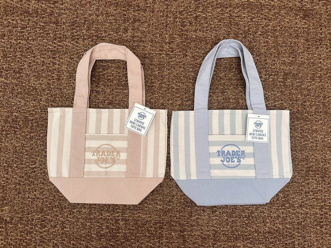Trader Joe's Striped Mini Canvas Tote Bag (Category: Tote Bags) located in Paranaque City. Submitted by threadup (Listing ID 1467392424, Image 1). Description: - Authentic Trader Joe's mini canvas tote bag - Available in 2 color options: Pink Stripes and Blue Stripes - Classic structured shape with a flat bottom - Made from durable, sturdy cotton fabric - Convenient front pocket featuring the embroidered Trader Joe's logo - Brand new with origina