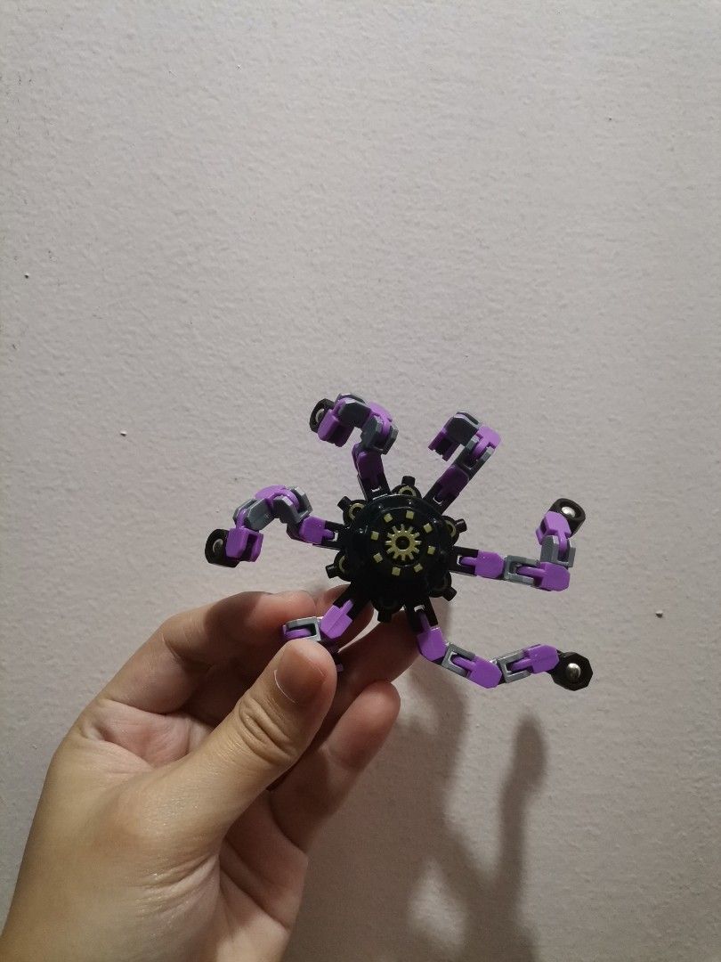 Transformable Multi-jointed Fidget Toy Spider Spinner (Category: Action & Battle Toys) located in Makati City. Submitted by kookybearsstuff (Listing ID 1467496533, Image 1). Description: - Purple and black transformable fidget toy - 6 flexible, articulated legs that bend into various shapes - Central hub with gear design on one side and textured emblem on the other - Smooth movement at all joints, perfect for stress relief - Clean condition and w