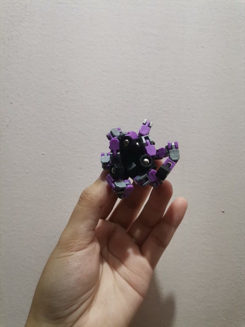 Transformable Multi-jointed Fidget Toy Spider Spinner (Category: Action & Battle Toys) located in Makati City. Submitted by kookybearsstuff (Listing ID 1467496533, Image 3). Description: - Purple and black transformable fidget toy - 6 flexible, articulated legs that bend into various shapes - Central hub with gear design on one side and textured emblem on the other - Smooth movement at all joints, perfect for stress relief - Clean condition and w