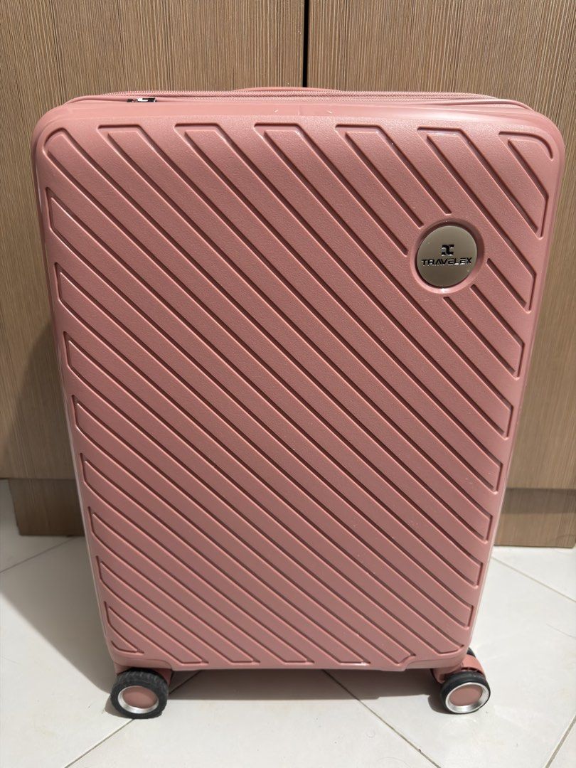 Travelex Pink Hard Shell Luggage Suitcase (Category: Luggage) located in Manila. Submitted by paojune (Listing ID 1467525421, Image 1). Description: - Brand: Travelex - Color: Stylish pink - Exterior: Durable hard shell with modern diagonal grooved pattern - Mobility: Smooth-rolling spinner wheels and telescopic handle - Security: Built-in TSA-approved combination lock - Closure: Secure zipper closure with dual pullers Dimensions - 54cm x 36cm x 