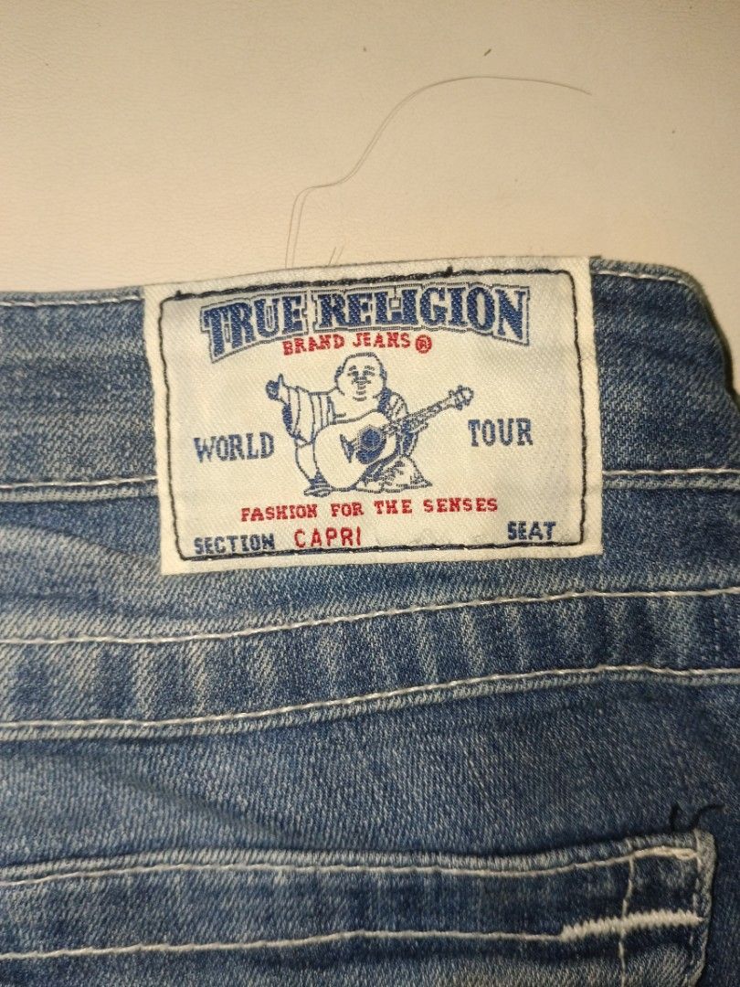 True Religion Rolled Capri Jeans Size 28 (Category: Jeans) located in Carcar. Submitted by rolandobac92675 (Listing ID 1467476091, Image 2). Description: - Brand: True Religion - Style: Denim capri pants - Size: 28 (approx. 16" flat waist) - Wash: Medium blue - Material: 99% cotton, 1% spandex - Details: Contrast stitching, jeweled front pocket accents, and signature button-flap back pockets - Origin: Made in Mexico.