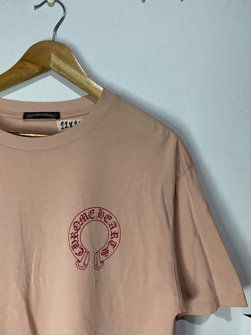 CHROME HEARTS TSHIRT (Category: Tshirts & Polo Shirts ) located in Jaen. Submitted by oshimamark58418 (Listing ID 1467525317, Image 3). Description: - Brand: Chrome Hearts - Color: Pastel Pink - Size: M-L (Measurements: 22 x 26 inches) - Design: Red horseshoe logo on the front left chest; large horseshoe and cross graphic print on the back - Fit: Relaxed, comfortable streetwear style - Condition: Good pre-owned condition - Perfect for daily casua