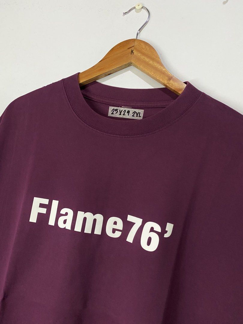 TSHIRT (Category: Tshirts & Polo Shirts ) located in Jaen. Submitted by oshimamark58418 (Listing ID 1467534141, Image 3). Description: - Color: Maroon - Size: 2XL (25" width x 29" length) - Front Design: 'Flame76' white print - Back Design: Large number '7' graphic with star - Condition: Excellent, well-maintained fabric - Perfect for casual and streetwear looks.