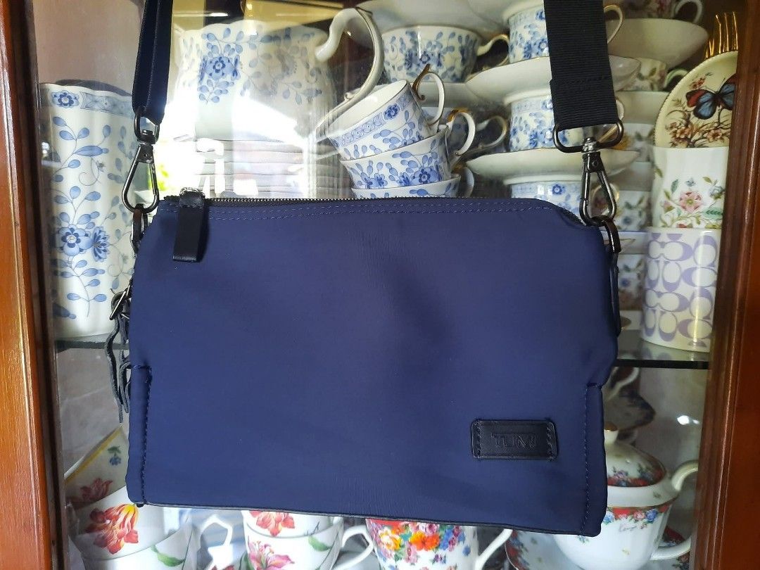 Tumi Blue Nylon Crossbody Bag (Category: Luxury Bags & Wallets) located in Manila. Submitted by boldfire_315559 (Listing ID 1467381841, Image 1). Description: - Authentic Tumi crossbody bag in stylish blue nylon - Accented with premium black leather and includes matching luggage tag - Secure zip top closure with clean exterior and interior fabric - Interior equipped with handy slip pockets and Tumi tracer metal plate - Features an adjustable stra