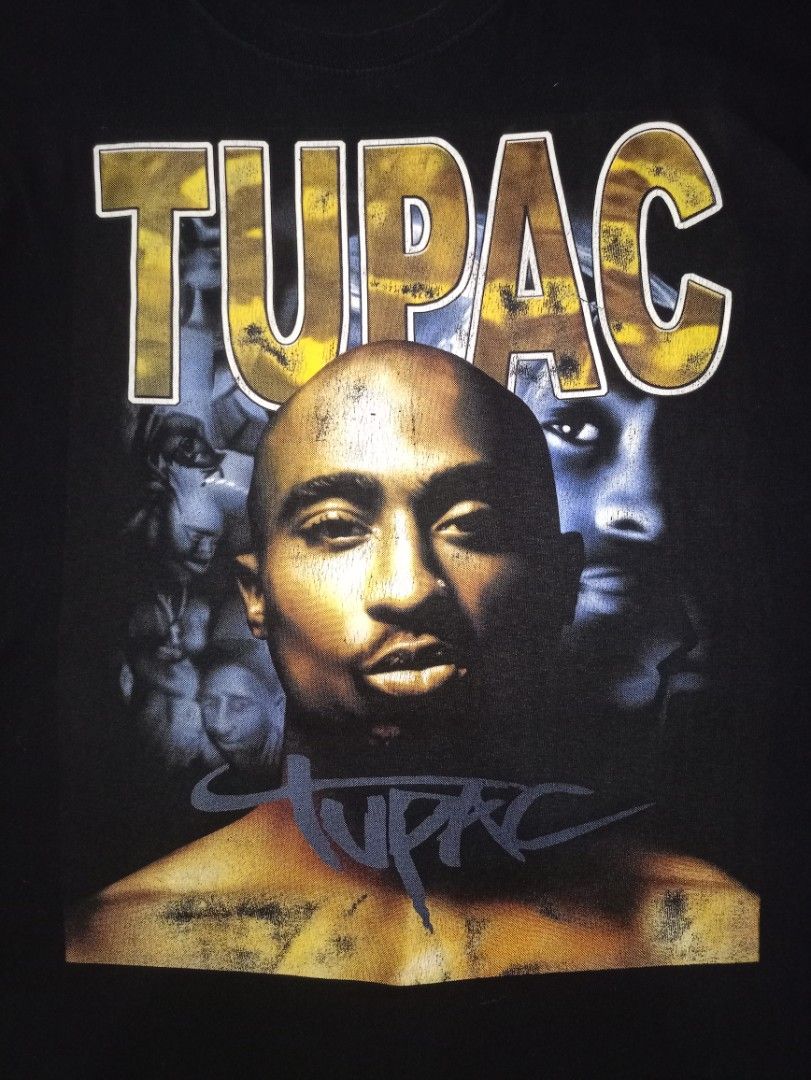 Tupac Graphic Print Black T-Shirt (Category: Tshirts & Polo Shirts ) located in Caloocan City. Submitted by grandturtle-371b8d (Listing ID 1467397299, Image 2). Description: - Color: Classic Black - Design: Bold Tupac graphic print with lettering on both front and back - Fit: Standard fit with short sleeves and crew neck - Style: Vintage hip-hop aesthetic, heavy-duty chest prints - Versatility: Easy to style with jeans, cargo pants, or joggers - 