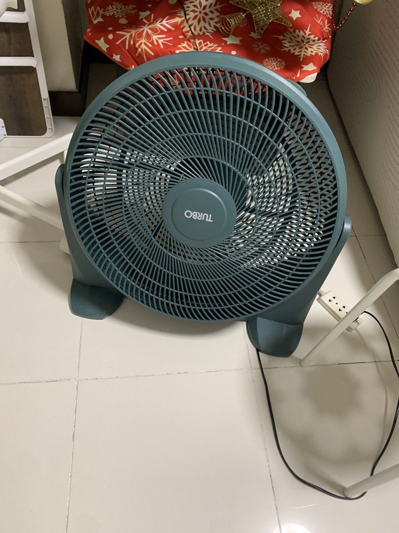 Turbo Floor Fan Blue (Category: Fans) located in Manila. Submitted by homepreneurglobal (Listing ID 1467479143, Image 1). Description: - Color: Dark green / dark teal - Design: Low-sitting floor fan with sturdy plastic feet and round cage - Power: Standard plug for normal wall sockets - Performance: Powerful turbo airflow, great for room circulation - Condition: No issues. Good as new - Reason for selling: Upgrading to wall fan - Available: 2 pcs