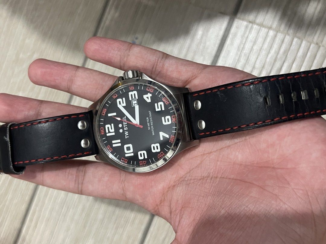 TW Steel TW411 Pilot Watch (Category: Luxury Watches) located in Cebu City. Submitted by lilathestar (Listing ID 1467573067, Image 1). Description: Details: • Brand: TW Steel • Black dial with white numerals and red accents • Silver-tone stainless steel case • Black strap with red stitching • Water-resistance marking: 5 ATM • Condition: Used, with slightly visible scratches from normal wear • Battery: Not working Selling as-is. Please review the 
