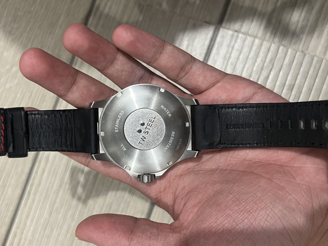 TW Steel TW411 Pilot Watch (Category: Luxury Watches) located in Cebu City. Submitted by lilathestar (Listing ID 1467573067, Image 3). Description: Details: • Brand: TW Steel • Black dial with white numerals and red accents • Silver-tone stainless steel case • Black strap with red stitching • Water-resistance marking: 5 ATM • Condition: Used, with slightly visible scratches from normal wear • Battery: Not working Selling as-is. Please review the 