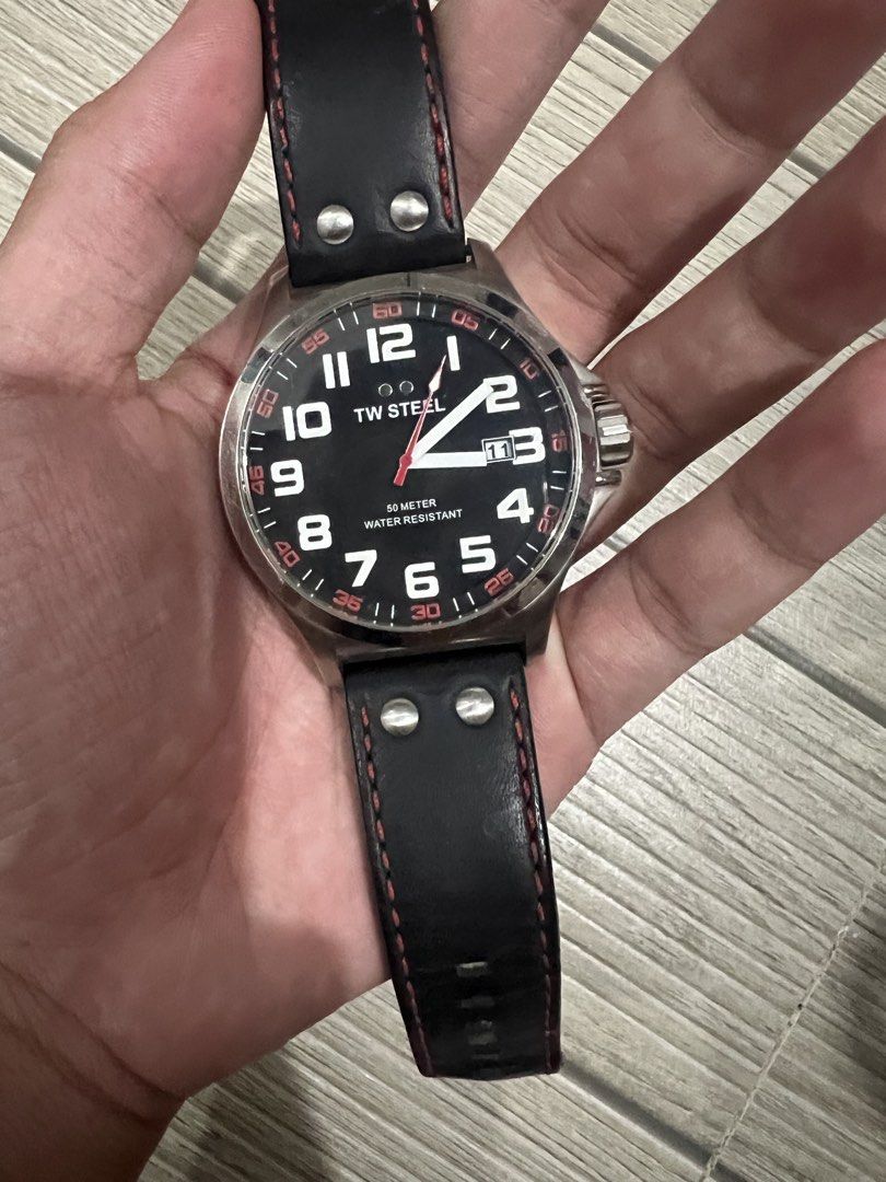 TW Steel TW411 Pilot Watch (Category: Luxury Watches) located in Cebu City. Submitted by lilathestar (Listing ID 1467573067, Image 2). Description: Details: • Brand: TW Steel • Black dial with white numerals and red accents • Silver-tone stainless steel case • Black strap with red stitching • Water-resistance marking: 5 ATM • Condition: Used, with slightly visible scratches from normal wear • Battery: Not working Selling as-is. Please review the 