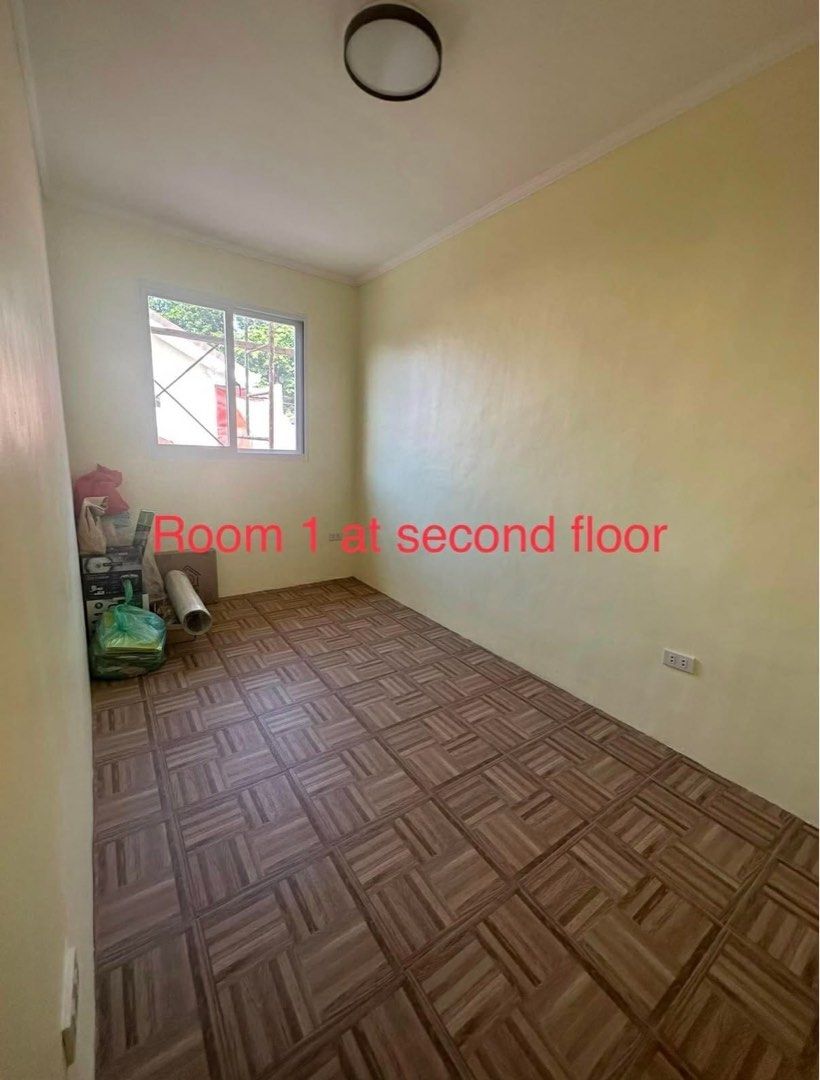 Two storey house with 2 bedrooms and balcony (Category: House & Lot) located in Manila. Submitted by brington_5e7647 (Listing ID 1467390374, Image 2). Description: - Two-storey house with eye-catching yellow exterior and red roof - Gated front yard with designated car space - Spacious interior with high ceilings and a classic wooden staircase - Elegant parquet flooring in the rooms - Living area connected by stylish arched doorways - Fresh walls 