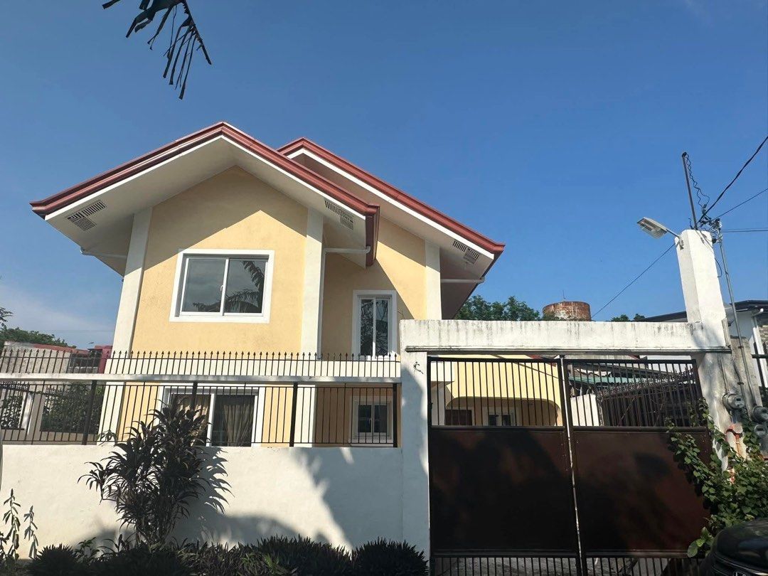 Two storey house with 2 bedrooms and balcony (Category: House & Lot) located in Manila. Submitted by brington_5e7647 (Listing ID 1467390374, Image 1). Description: - Two-storey house with eye-catching yellow exterior and red roof - Gated front yard with designated car space - Spacious interior with high ceilings and a classic wooden staircase - Elegant parquet flooring in the rooms - Living area connected by stylish arched doorways - Fresh walls 