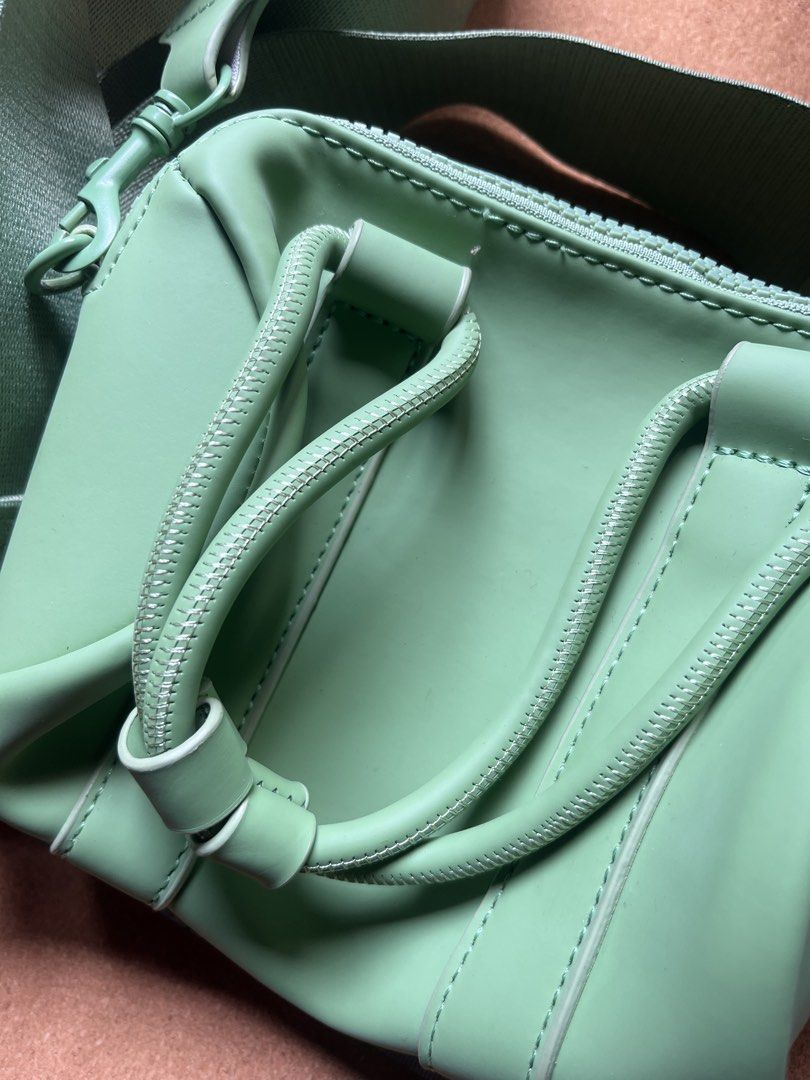 Typo Amelia Mini Duffel Bag Green (Category: Cross-body Bags) located in Baguio. Submitted by gaara1234 (Listing ID 1467381483, Image 3). Description: - Brand: Typo - Style: Crossbody bag with structured handles and adjustable strap - Color: Vibrant mint green (outer), lighpink (lining) - Material: Polyurethane outer, polyester lining - Closure: Zip closure with branded Typo puller - Condition: Clean interior with original care and material tags 