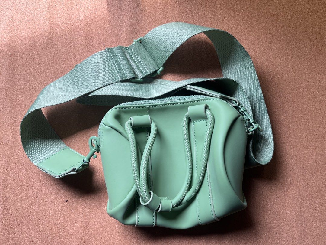 Typo Amelia Mini Duffel Bag Green (Category: Cross-body Bags) located in Baguio. Submitted by gaara1234 (Listing ID 1467381483, Image 1). Description: - Brand: Typo - Style: Crossbody bag with structured handles and adjustable strap - Color: Vibrant mint green (outer), lighpink (lining) - Material: Polyurethane outer, polyester lining - Closure: Zip closure with branded Typo puller - Condition: Clean interior with original care and material tags 