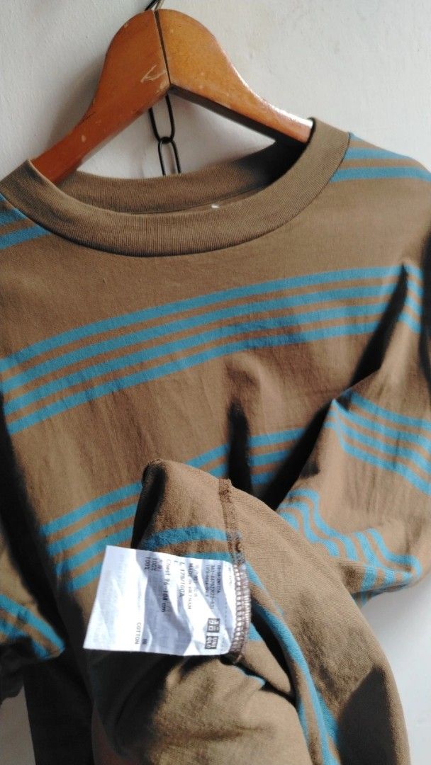 Uniqlo U Brown Blue Striped Tee (Category: Shirts) located in Cavite. Submitted by ukaynglahat (Listing ID 1467380422, Image 3). Description: - Brand/Collection: Uniqlo U - Size: L - Color/Pattern: Brown with blue horizontal stripes - Material: 100% cotton - Fit: Classic crew neck with short sleeves - Origin: Made in Vietnam - Condition: Clean, solid fabric with no obvious flaws.