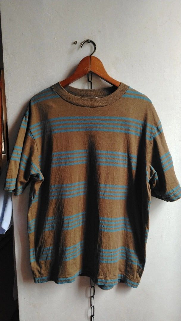 Uniqlo U Brown Blue Striped Tee (Category: Shirts) located in Cavite. Submitted by ukaynglahat (Listing ID 1467380422, Image 1). Description: - Brand/Collection: Uniqlo U - Size: L - Color/Pattern: Brown with blue horizontal stripes - Material: 100% cotton - Fit: Classic crew neck with short sleeves - Origin: Made in Vietnam - Condition: Clean, solid fabric with no obvious flaws.