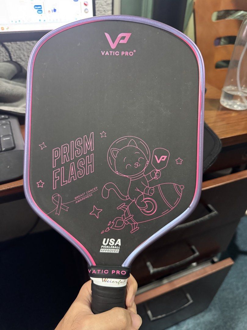 Vatic Pro Prism Flash Space Cat Pickleball Paddle (Category: Racket and Ball Sports) located in Manila. Submitted by markgapac_08 (Listing ID 1467416738, Image 1). Description: - Limited edition Space Cat graphic design - Stylish pink accents with a sleek black carbon fiber surface - USA Pickleball approved for official matches - Standard grip wrapped in black tape with a branded band - Includes original protective zippered cover with pink logo -