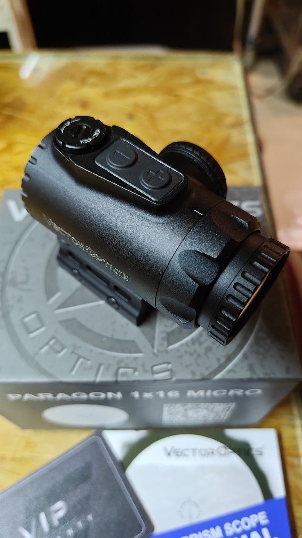 Vector Optics Paragon 1x16 Micro Prism Scope (Category: Lens & Kits) located in Caloocan City. Submitted by sixthsoul.sense (Listing ID 1467526424, Image 3). Description: - Model: Vector Optics Paragon 1x16 Micro Prism Scope - Color: Sleek black finish - Controls: Top button controls with a convenient side illumination dial - Mount: Attached mount on the bottom rail ready for setup - Inclusions: Original retail box, user manual, and VIP warranty 