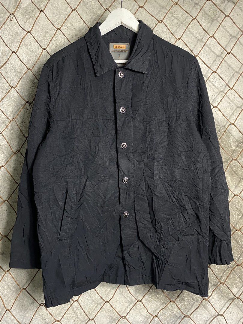 Versace Black Casual Jacket (Category: Coats, Jackets and Outerwear) located in Cabanatuan. Submitted by brightwater-2083 (Listing ID 1467520552, Image 1). Description: Black Versace jacket with button closure and front pockets. Textured fabric with inner lining. Branded silver-tone metal buttons featuring the Medusa head motif. Tag on the inside collar shows Versace branding and care instructions. Width 22.5 Length 29.5.