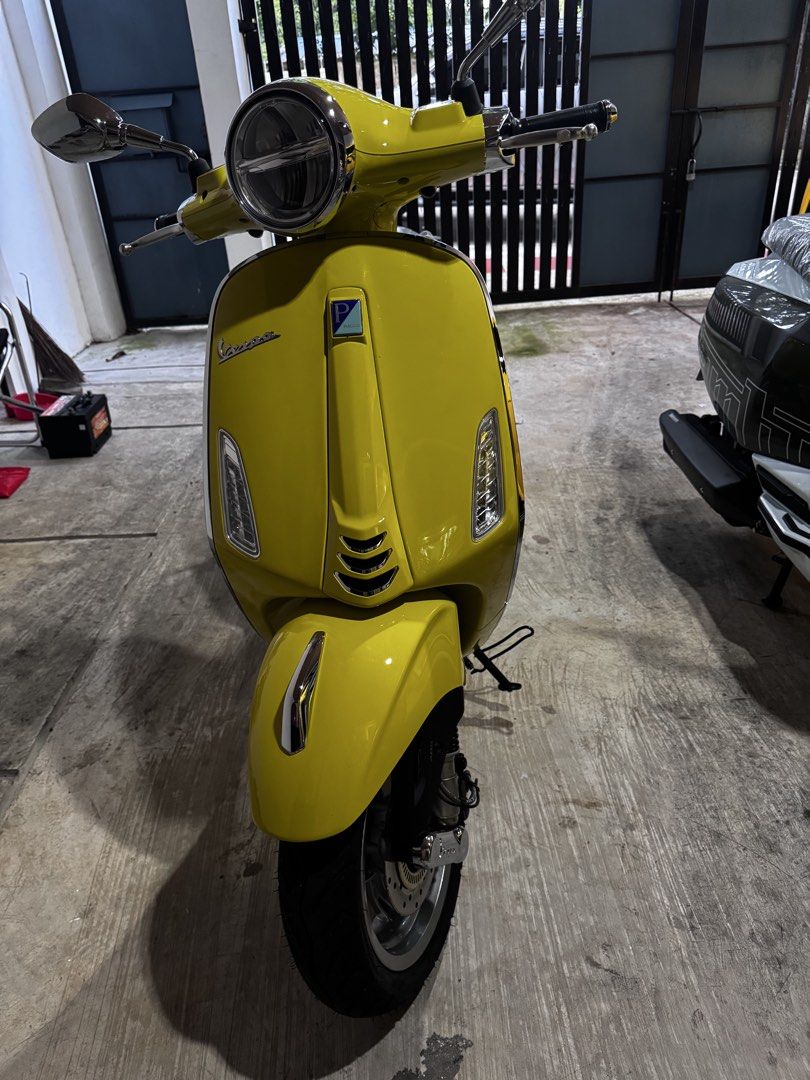 Vespa Primavera 150 Scooter Yellow (Category: Skates, Rollerblades & Scooters) located in Makati City. Submitted by lesliit (Listing ID 1467517604, Image 1). Description: - Color: Bright yellow with clean, well-maintained paintwork - Condition: Stored indoors, excellent overall condition with seat still wrapped in protective plastic - Design: Classic retro look featuring a round headlight and iconic Vespa branding badges - Hardware: Dual chrome h