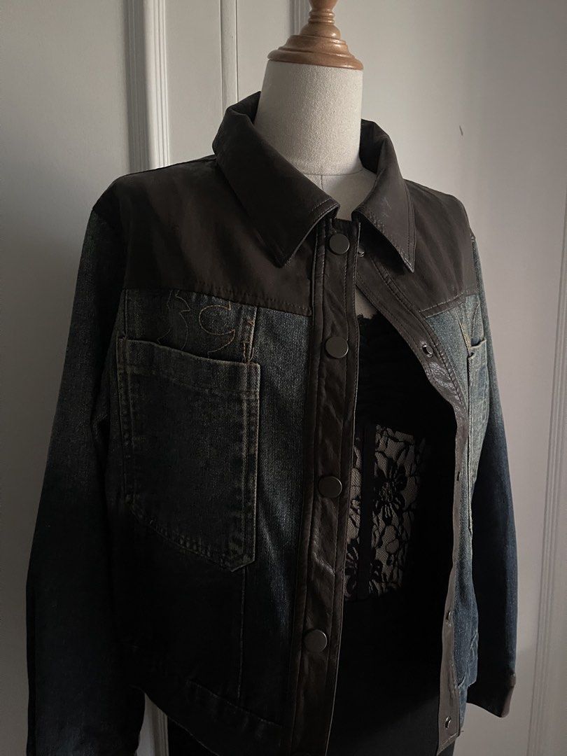 Vintage Brown Leather and Denim Panel Jacket (Category: Coats, Jackets and Outerwear) located in Cavite. Submitted by devilourea (Listing ID 1467483861, Image 3). Description: - Two-tone design combining dark brown leather on top with faded blue denim on the body and sleeves - Button-up front with secure snap closures and a classic pointed collar - Two functional chest pockets featuring subtle embroidery detail above the right pocket - Stylish cu