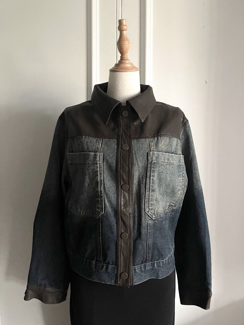 Vintage Brown Leather and Denim Panel Jacket (Category: Coats, Jackets and Outerwear) located in Cavite. Submitted by devilourea (Listing ID 1467483861, Image 1). Description: - Two-tone design combining dark brown leather on top with faded blue denim on the body and sleeves - Button-up front with secure snap closures and a classic pointed collar - Two functional chest pockets featuring subtle embroidery detail above the right pocket - Stylish cu