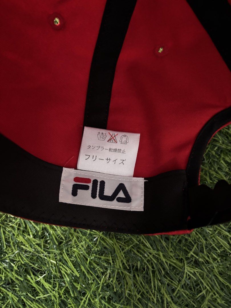 Vintage Fila Red Cap Hat Adjustable (Category: Caps & Hats) located in Makati City. Submitted by rare_thrift_stuff (Listing ID 1467371452, Image 3). Description: - Color: Bright red with white and dark blue embroidered Fila logo - Fit: Adjustable strap back with Fila branding on the clasp - Details: Inside tag features Japanese sizing and care instructions - Condition: Clean fabric, no stains or visible wear.