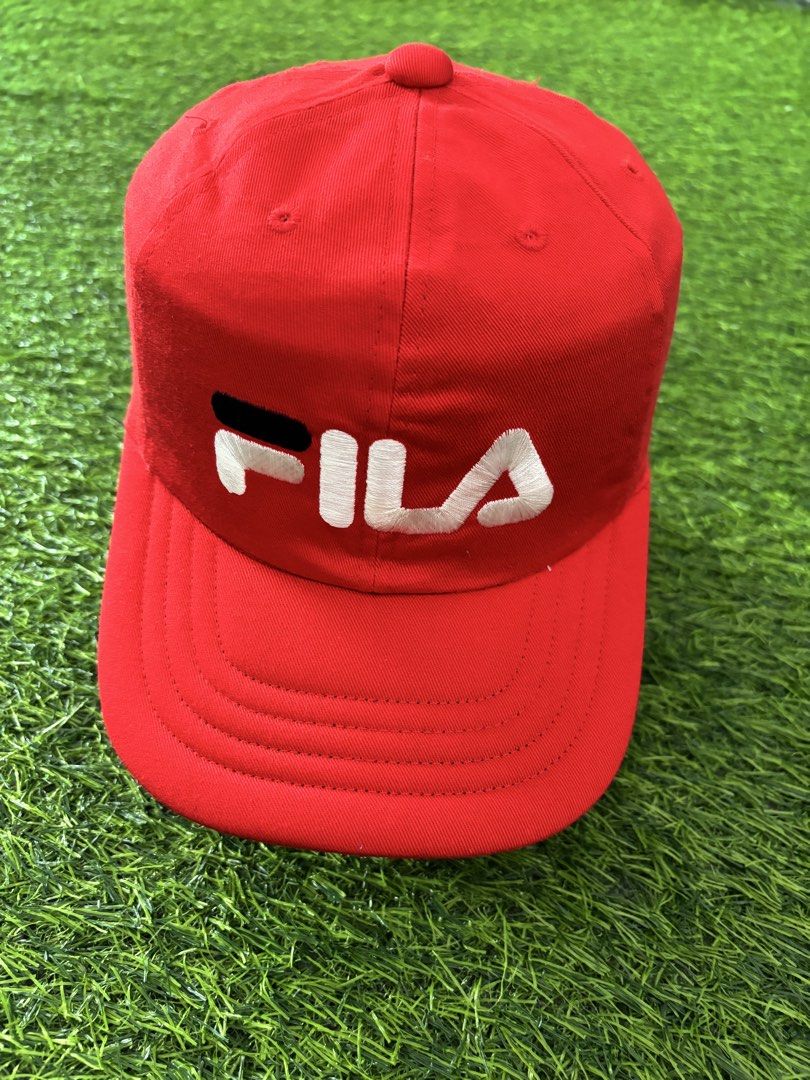 Vintage Fila Red Cap Hat Adjustable (Category: Caps & Hats) located in Makati City. Submitted by rare_thrift_stuff (Listing ID 1467371452, Image 1). Description: - Color: Bright red with white and dark blue embroidered Fila logo - Fit: Adjustable strap back with Fila branding on the clasp - Details: Inside tag features Japanese sizing and care instructions - Condition: Clean fabric, no stains or visible wear.