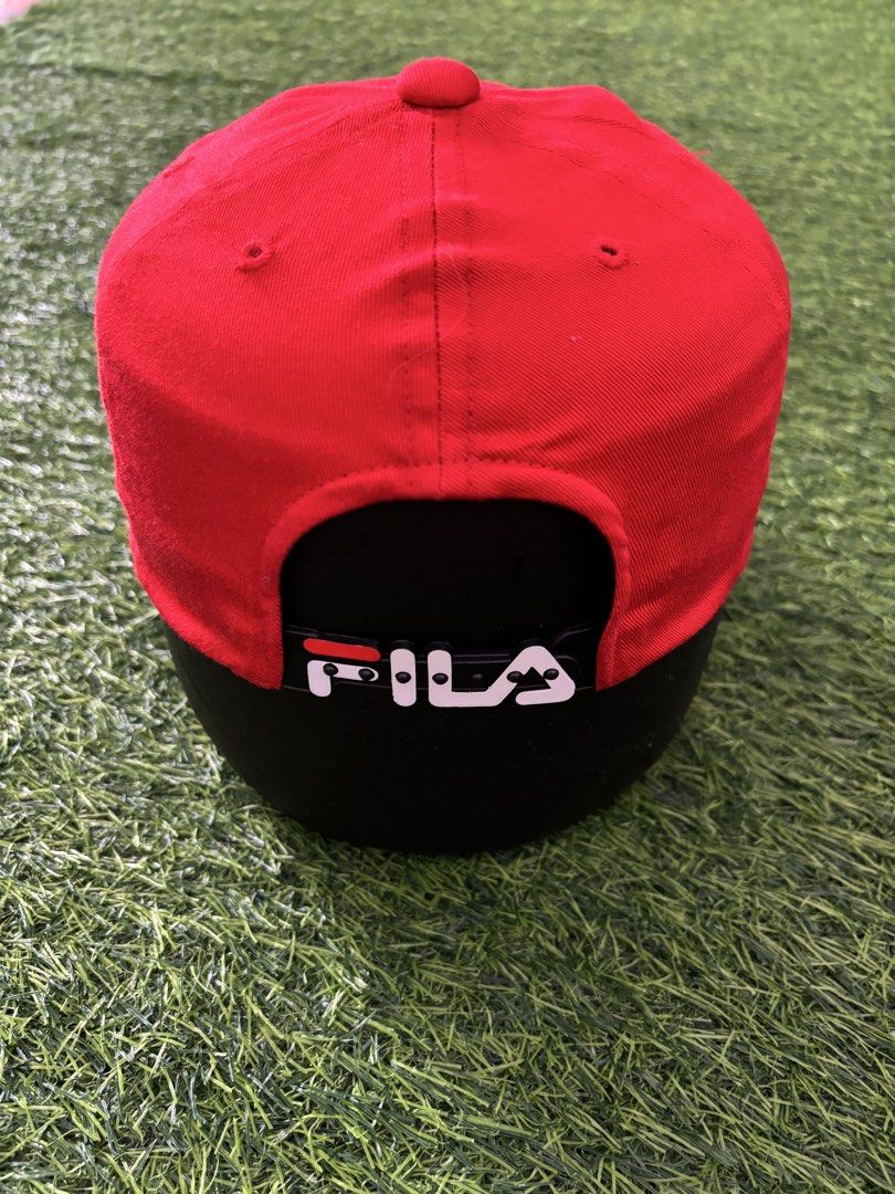 Vintage Fila Red Cap Hat Adjustable (Category: Caps & Hats) located in Makati City. Submitted by rare_thrift_stuff (Listing ID 1467371452, Image 2). Description: - Color: Bright red with white and dark blue embroidered Fila logo - Fit: Adjustable strap back with Fila branding on the clasp - Details: Inside tag features Japanese sizing and care instructions - Condition: Clean fabric, no stains or visible wear.