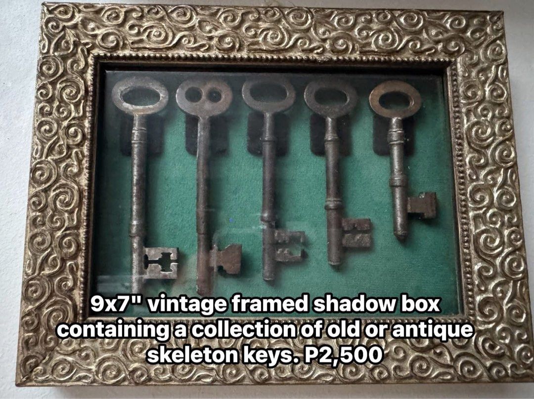 Vintage Framed Shadow Box with Antique Skeleton Keys (Category: Frames & Pictures) located in Cainta. Submitted by elainelawenko (Listing ID 1467420162, Image 1). Description: - Vintage shadow box wall decor with a glass front - Holds five authentic antique skeleton keys mounted on rich green velvet - Ornate gold-colored textured frame featuring a classic scrollwork design - Dimensions: Approximately 11 inches by 7 inches - Ready to hang in your 