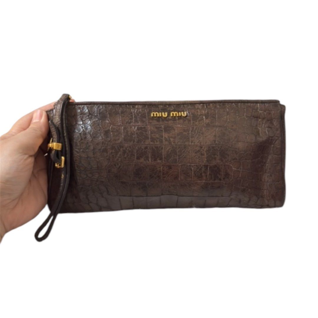 Vintage Miu Miu Wrislet Pouch (Category: Clutches) located in Paranaque City. Submitted by dalle_closet (Listing ID 1467430258, Image 1). Description: genuine leather natatanggal na yung coating niya na dark brown. tanggalin niyo nalang lahat. .