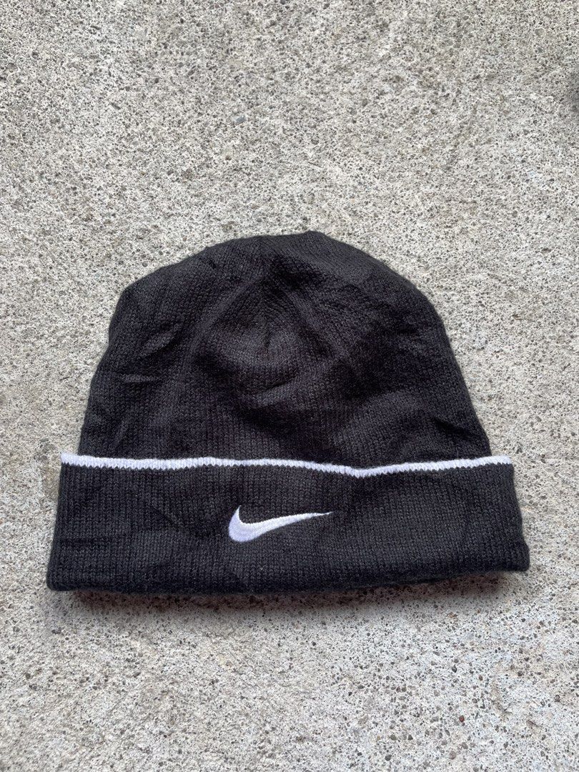 Vintage Nike Black Beanie Hat (Category: Caps & Hats) located in Siniloan. Submitted by rethr1ft (Listing ID 1467420164, Image 1). Description: - Brand: Nike - Color: Classic black with white swoosh embroidery and stripe detail - Material: 100% acrylic (warm and cozy) - Origin: Made in Taiwan - Size: One size fits all - Condition: Great for cold weather or everyday streetwear.
