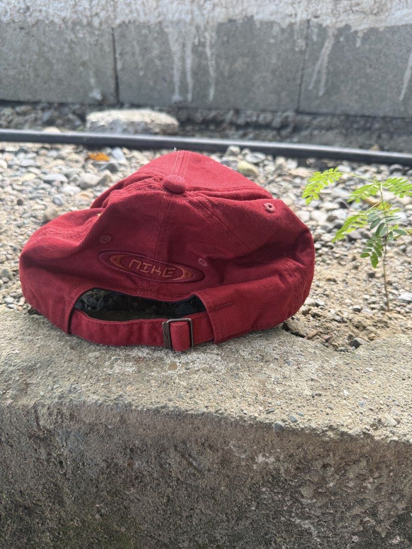 Vintage Nike Maroon Cap (Category: Caps & Hats) located in Burgos, Ilocos Norte. Submitted by copthrift (Listing ID 1467371743, Image 2). Description: - Brand: Nike - Style: Classic retro dad hat - Color: Maroon with dark grey inner lining - Details: Embroidered Nike logo on the front and back - Fit: Adjustable strap with a metal buckle.